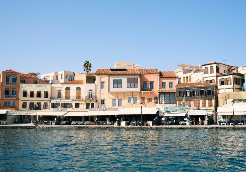 Belmondo Hotel — Chania Venetian harbor waterfront with colorful buildings and tavernas